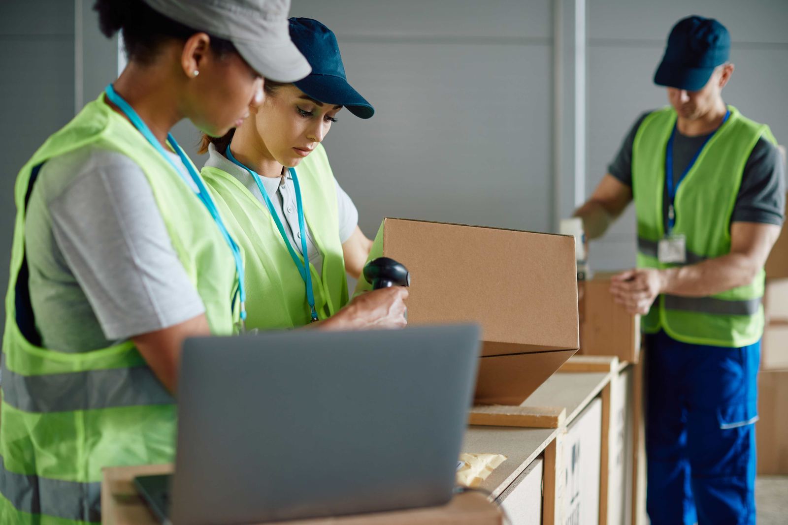 Warehouse staff scanning packages during intake